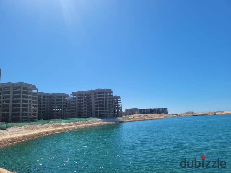 First row apartment directly on the lagoon  fully finished  immediate delivery  in front of El Alamein Towers in the Latin district 7