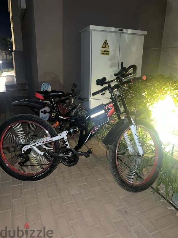 adult bicycle with drink holder and two bags 0