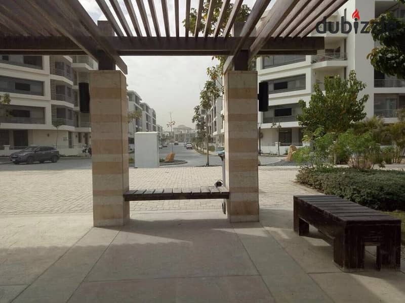 Studio with private garden for sale in the first settlement in front of the airport in Taj City Compound 9