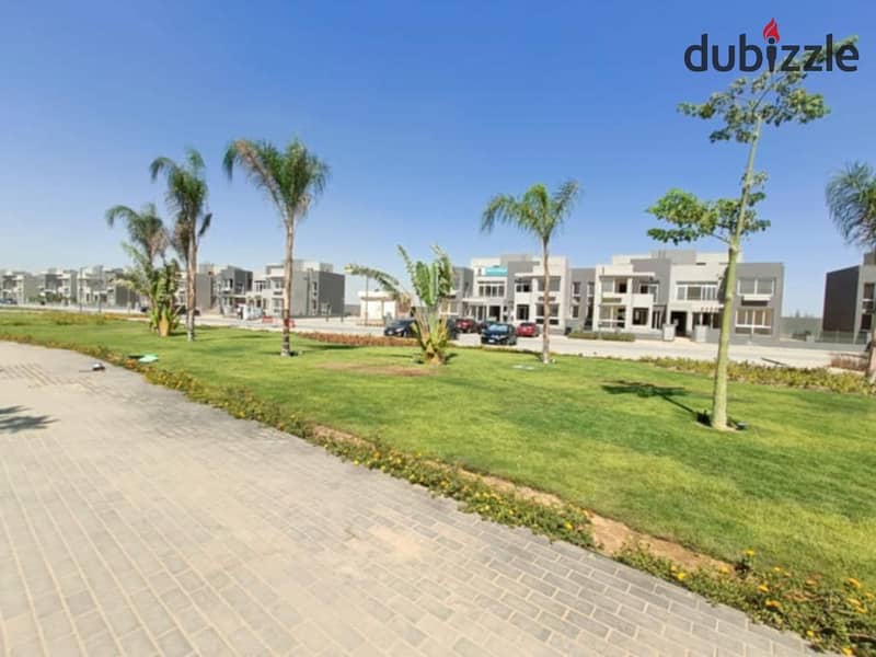 Apartment with garden for sale, fully finished, ready for immediate delivery, with all amenities, in Kian October Compound, with a distinctive view of 12