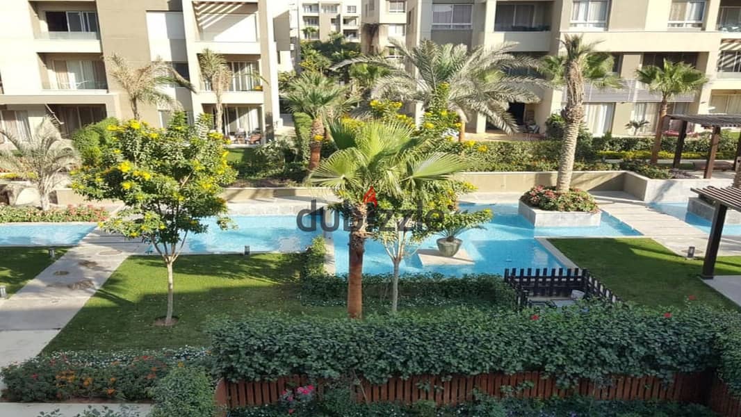 2 bedroom apartment for sale with open view of landscape and wide green spaces in Swan Lake Residence Compound, Hassan Allam, New Cairo, in front of R 10