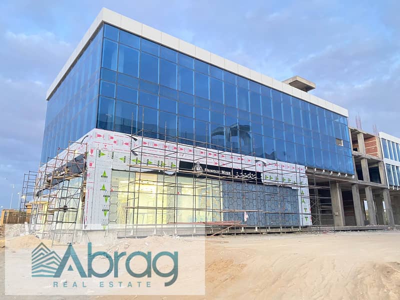 For sale, a commercial store, 125 square meters, immediate delivery, with facilities up to 4 years, West Eleven Mall, in front of Misr University 14