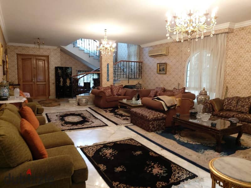 Private villa for sale, 750 square meters, with a swimming pool and a large private garden, next to Mall of Egypt, Wadi Degla Club, and on Al Wahat Ro 8