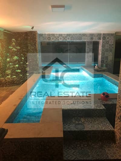 Villa with garden for sale, 500 square meters, 4 rooms, landscape view, indoor and outdoor swimming pool, camera system, and alarm, Prime Location.