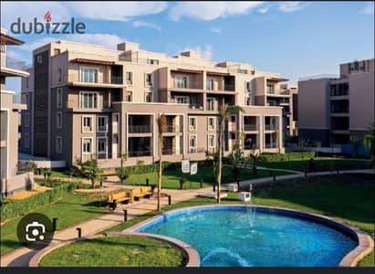 Receive immediately an apartment for sale with an independent garden and a lagoon view in October Plaza, Sodic, in installments