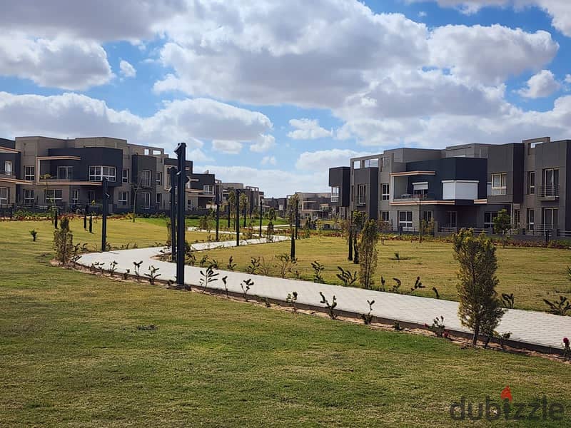 Ground floor apartment with a garden, immediate delivery, fully finished, double view, in Sheikh Zayed, in the heart of Grand Heights, in installments 9