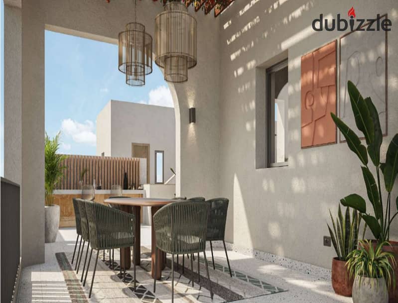 The user lives in O West in a 400-square-meter villa, purchased through a long-term installment plan, in a prime location directly on Al Wahat Road. 5