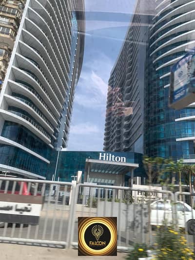 First row apartment on the Nile, immediate receipt under Hilton management, fully finished + air conditioning, in installments in Nile Pearl Towers