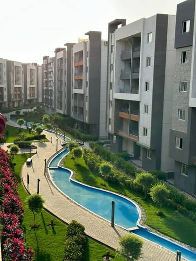 Apartment for sale in installments in October, Bahri face, third floor, with a distinctive view of water bodies and landscape in Rock Eden Compound . .