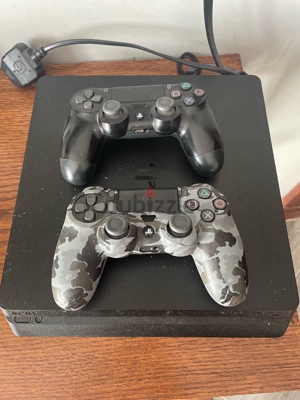 ps4 slim 1 Tb good condition with 2 controllers , 10 games , ps bag 1