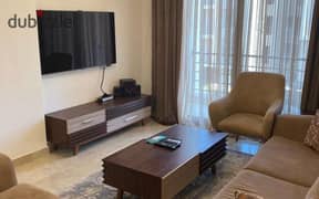 For sale, an apartment of 125 square meters ((resale)) in Fifth Square, Al Marasem, finished with wood, kitchen, air conditioners, and garage 0