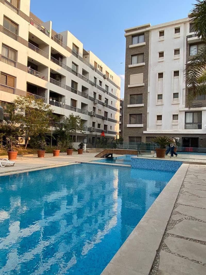 Apartment for sale in installments near Heliopolis and the Ring Road, third floor, with landscape and lagoon view. . . | Taj City - Nasr City - Rehab - 1