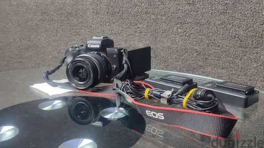 M50 canon + حامل كاميرا + مايكروفون بويا + 3 بطاريات + 2 شواحن