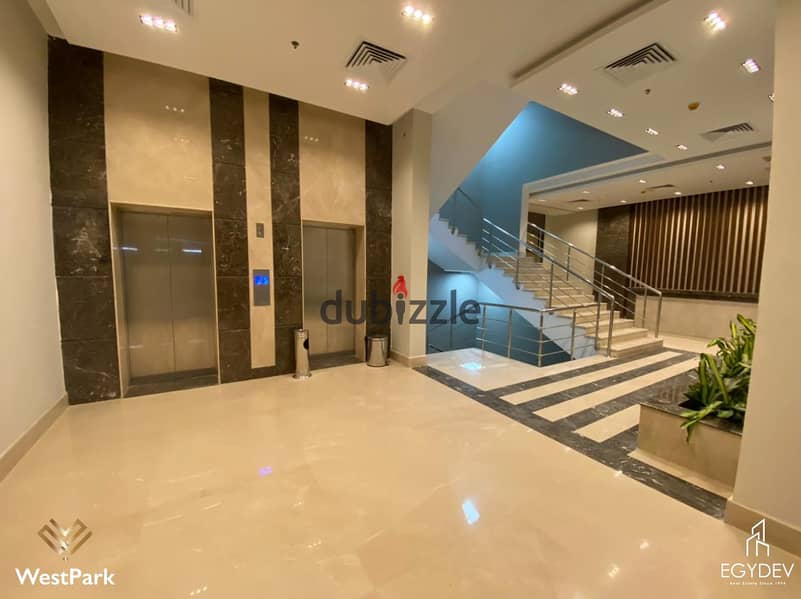 clinic 57-meter  for rent, ultra-super finished, in West Park Mall, 6th of October, Gamal Abdel Nasser Axis, directly in front of Mall of Arabia 2