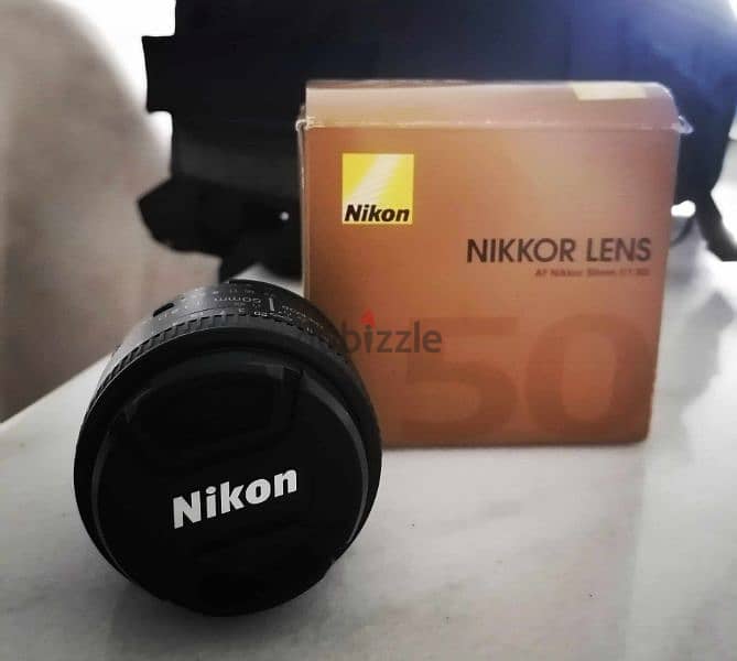 عدسة نيكون Nikon 50mm 1.8 للبيع بدون خربوش واحد بحاله الزيرو 1