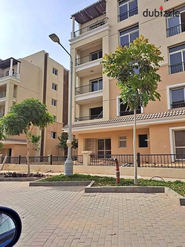 On the Suez Road next to Madinaty a ground floor apartment with a garden 3 rooms for sale in installments in Sarai New Cairo Madinaty near the gates 0