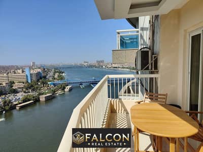 For sale, a fully furnished apartment with appliances, overlooking the Nile directly, with a panoramic view, immediate delivery + hotel finishing, in