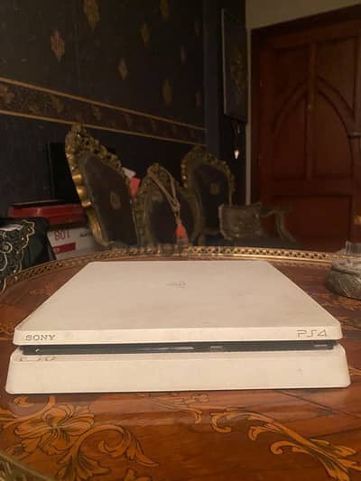 PlayStation 4 slim with 2 controllers and 2 games