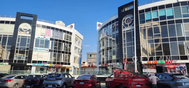 A shop for sale and investment in a commercial mall in First Settlement, Services of Al-Banafseg, behind Waterway, currently leased to a café.