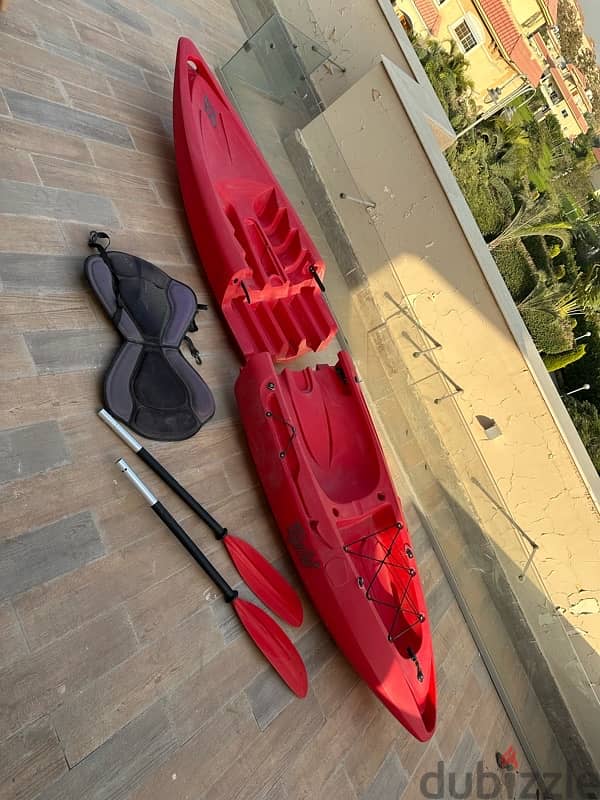 Red Kayak with paddle 2