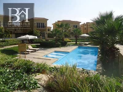 A villa for sale with a stunning view of artificial lakes within a prestigious compound in New Cairo.