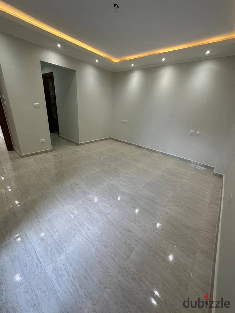 For sale with a down payment of 1,150,000, a fully finished 4-room apartment in New Cairo on Suez Road, two minutes from Al-Rehab and 10 minutes from 0