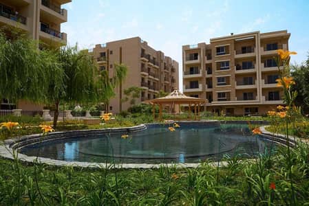 With a view of the golf courses and installments over 12 years, a 3-room apartment for sale on the Suez Road in Taj City  New Cairo