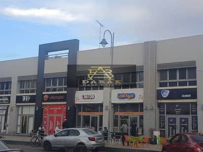 For rent, fully finished shop in Madinaty, prime location in front of the Craft Zone, opposite the wholesale market.