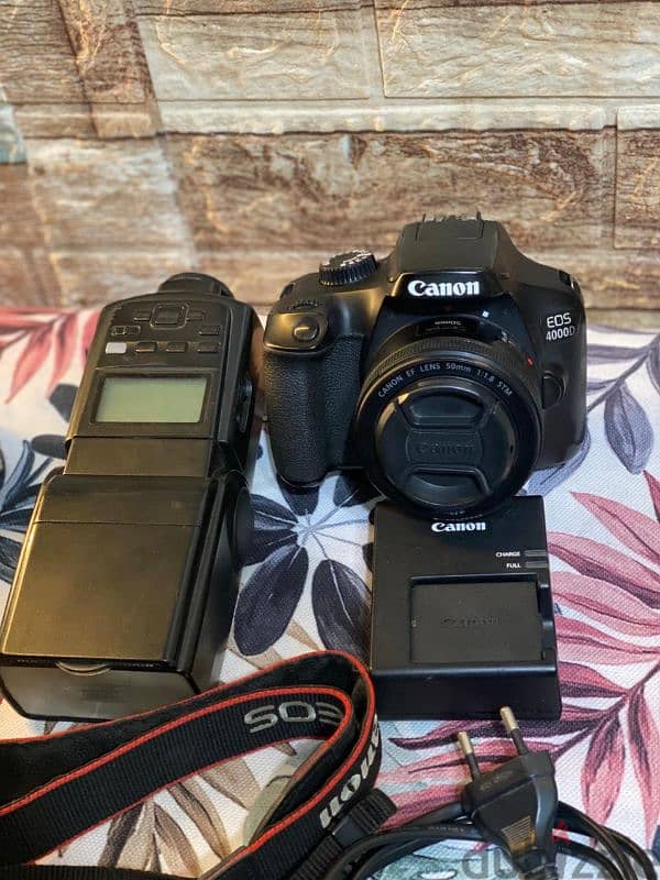 canon D4000 lens 50m stm كسر زيرو بكل مشتملاتها وفلاش 680 0