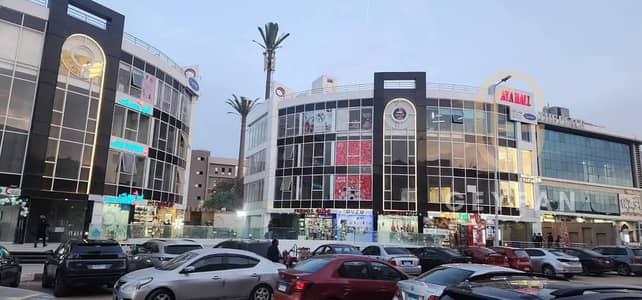 A prime shop for sale, ideal for investment, in a commercial mall with cafes.   It generates a monthly income of 40,000 EGP for 3 years.   The shop is