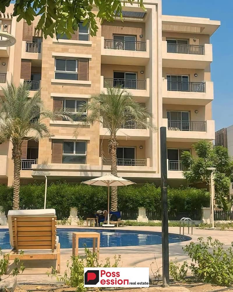 Apartment with private garden for sale in front of Cairo Airport on Suez Road, New Cairo, in installments over 12 years, Taj City Compound 0