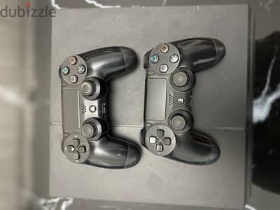 playstation 4 with two controllers