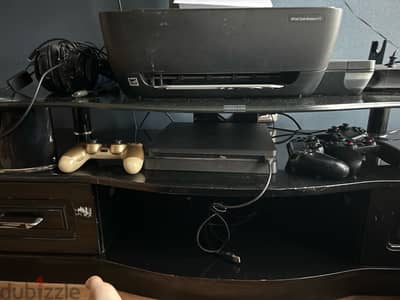 playstation4 with 4 controllers and a headset