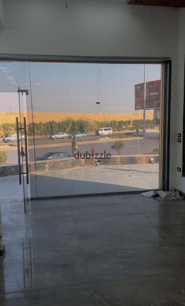 Shop for rent on Waslet Dahshur at a special price, internal area 100 m + 190 m outdoor area, near Mall of Egypt, 26 July Corridor, and Sheikh Zayed 0