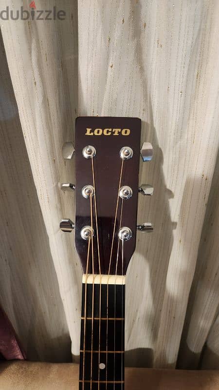 Locto Acoustic guitar with new strings with no scratches like new 1