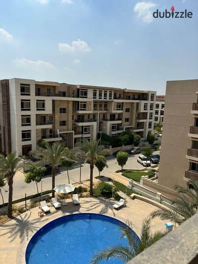 For sale, a triple view apartment in Taj City Compound, directly on the Suez Road