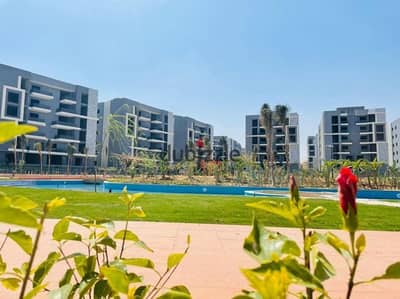 Apartment for sale in Garden City, in installments, with a very special view on the Escape land on the Suez Road, in Amd Compound, Rehab City