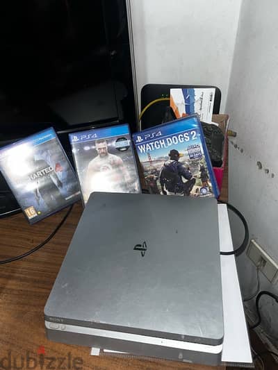 silver PlayStation 4 with 1 joystick and 3 games