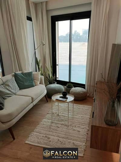 Stone villa directly on the lagoon, prime location for sale in Telal East Compound, Fifth Settlement, New Cairo, next to Mountain View iCity and The M