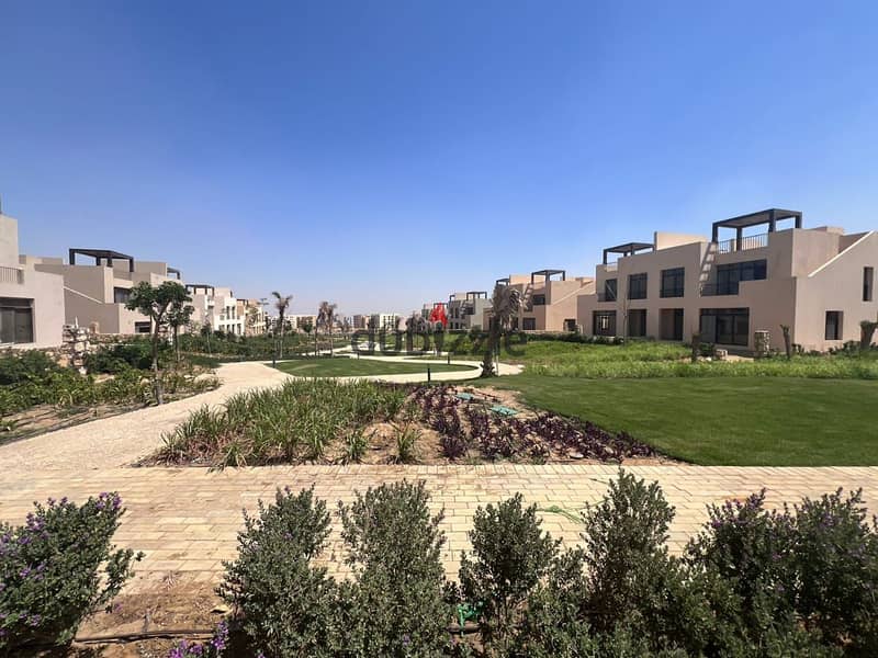 A finished villa with a lagoon view in Owest, Samih Sawiris, in front of Mall of Egypt, 0