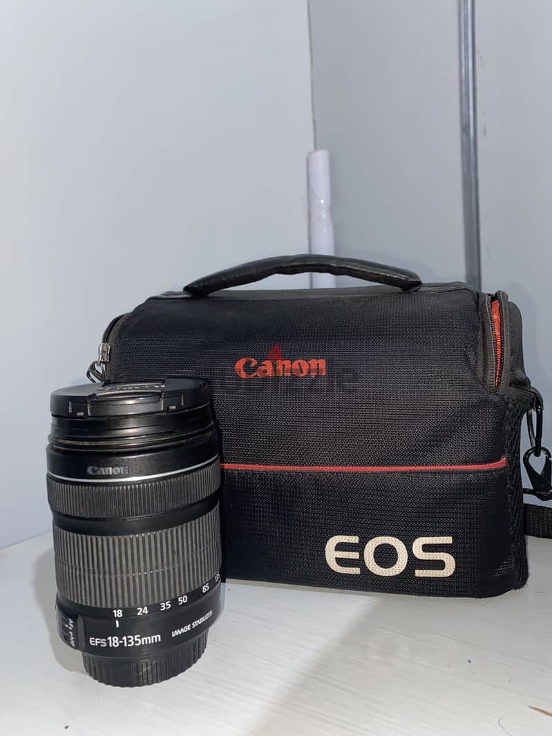 Canon 700D camera with an 18-135mm lens + battery + bag. 9