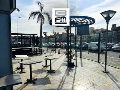 Fully finished restaurant for rent with a direct frontage on Mohammed Naguib Axis, located in the heart of New Cairo's Fifth Settlement. prime lo