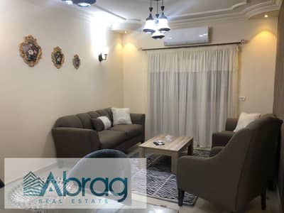 For rent, a two-bedroom apartment, furnished, air-conditioned, and equipped, in Rawdat Zayed Compound