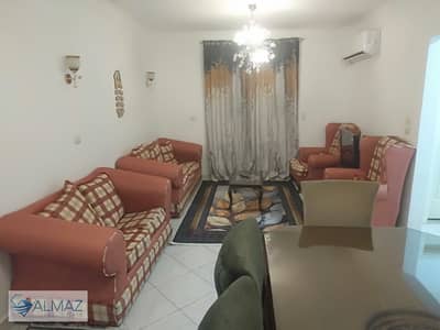 Furnished garden view apartment for rent with air conditioning in Gardenia City, Zone 10, with elevator in Nasr City.