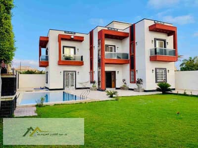 Furnished villa for rent in King Mariout, area 400m, ultra super lux, garden and swimming pool view of the lake. For more inquiries, please contact Mr. Omar, the office is located in King Mariout, directly after Al-Khars Restaurant.
