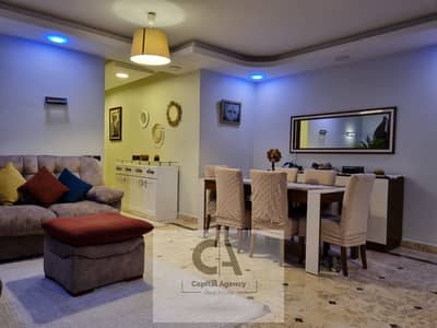 Apartment for sale, immediate delivery, fully finished and furnished, with a private garage in the heart of the Fifth Settlement in Highland Park