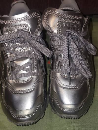 Girl's  Reebok silver shoes.