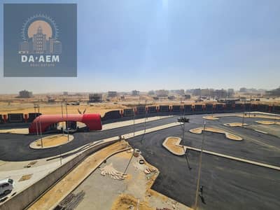 Double-fronted plot of land overlooking a garden in Beit Al Watan, New Cairo. The plot is 680 square meters, fully paid for, and includes a building p
