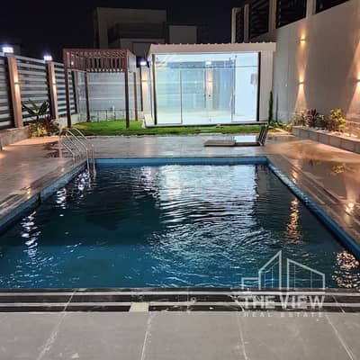 Luxury twin house for sale with a full view of Al Khamael Club, with a share of the land in Al Khamael Compound.