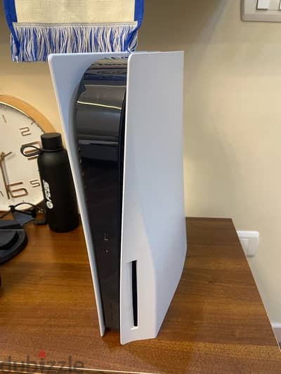 playstaion 5,2 controllers and a charging station